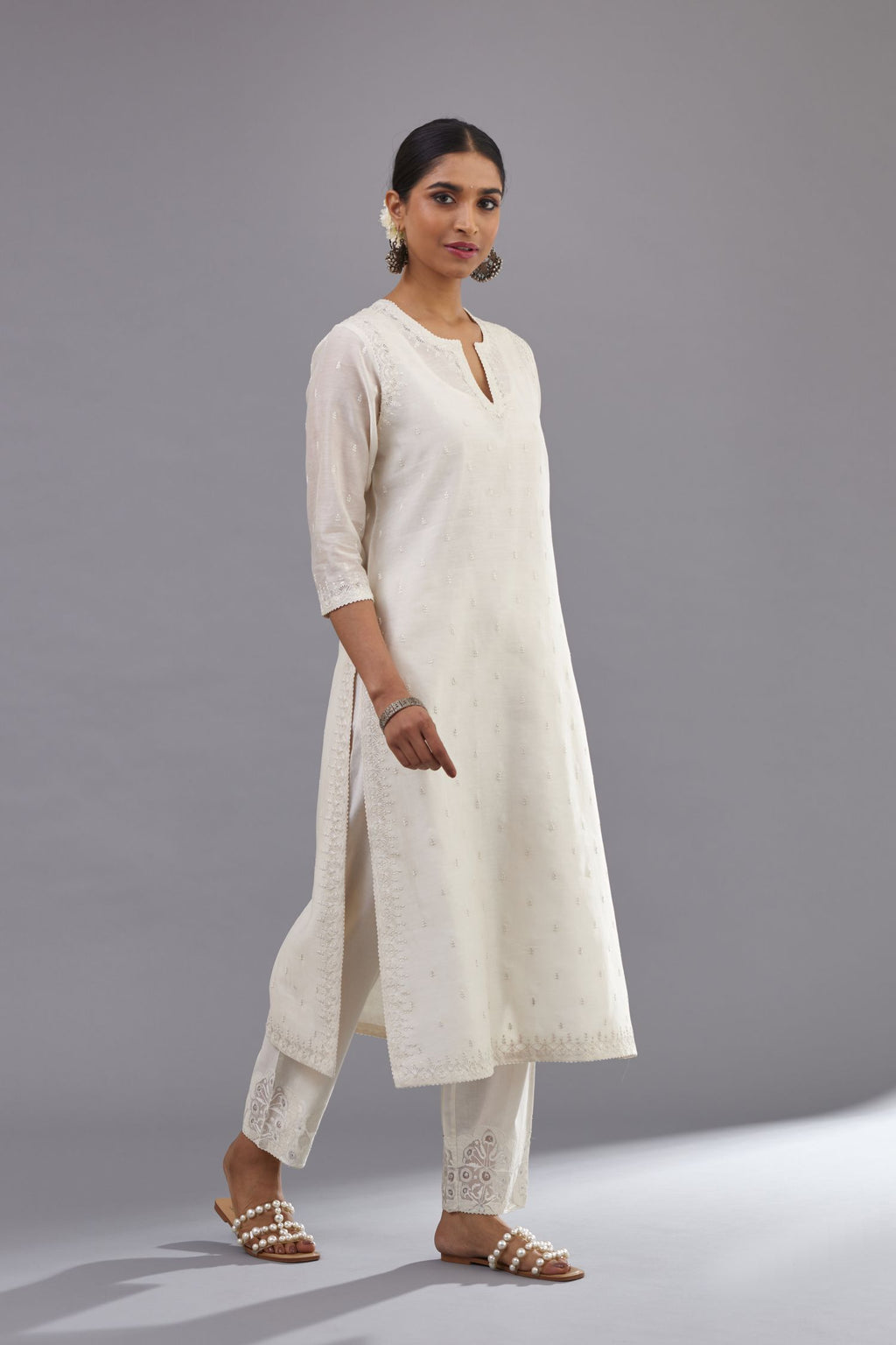 Off white silk chanderi straight kurta set with dori and silk thread embroidery at the neck, armholes, hem and sleeve cuffs.