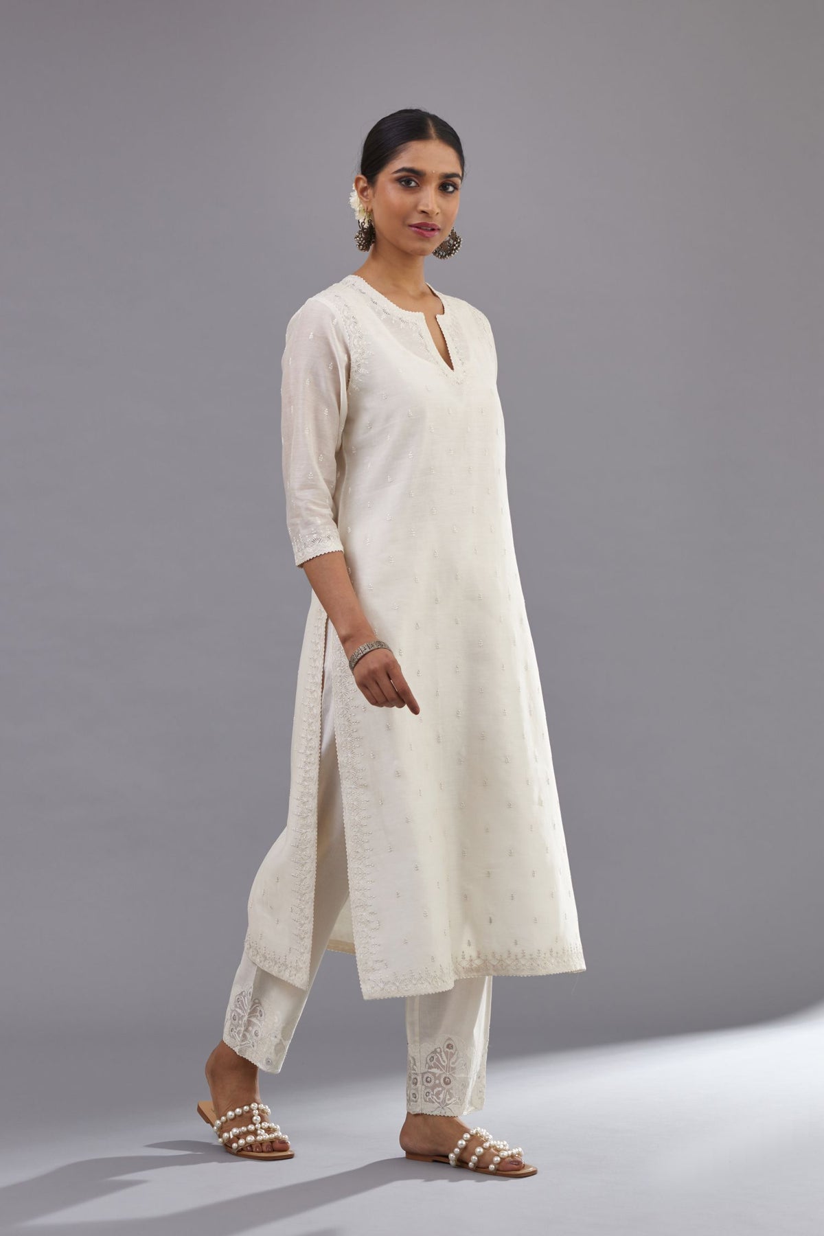 Off white silk chanderi straight kurta set with dori and silk thread embroidery at the neck, armholes, hem and sleeve cuffs.