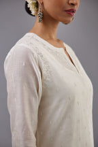 Off white silk chanderi straight kurta set with dori and silk thread embroidery at the neck, armholes, hem and sleeve cuffs.