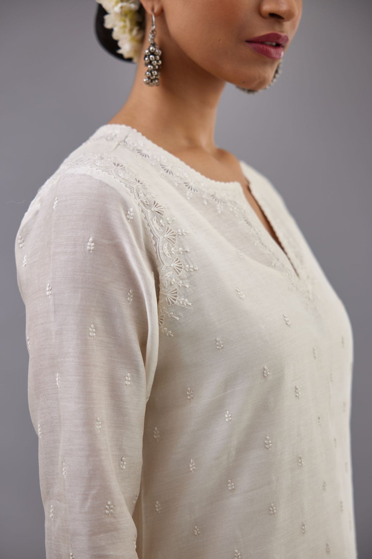 Off white silk chanderi straight kurta set with dori and silk thread embroidery at the neck, armholes, hem and sleeve cuffs.