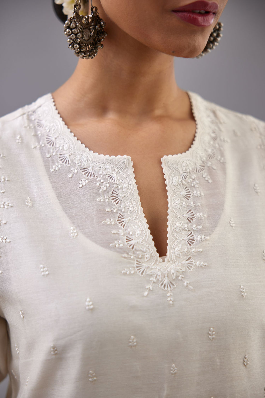 Off white silk chanderi straight kurta set with dori and silk thread embroidery at the neck, armholes, hem and sleeve cuffs.