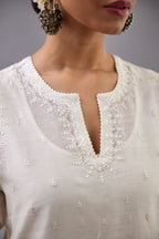 Off white silk chanderi straight kurta set with dori and silk thread embroidery at the neck, armholes, hem and sleeve cuffs.