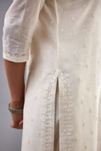 Off white silk chanderi straight kurta set with dori and silk thread embroidery at the neck, armholes, hem and sleeve cuffs.