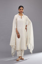 Off white silk chanderi straight kurta set with dori and silk thread embroidery at the neck, armholes, hem and sleeve cuffs.