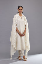Off white silk chanderi straight kurta set with dori and silk thread embroidery at the neck, armholes, hem and sleeve cuffs.