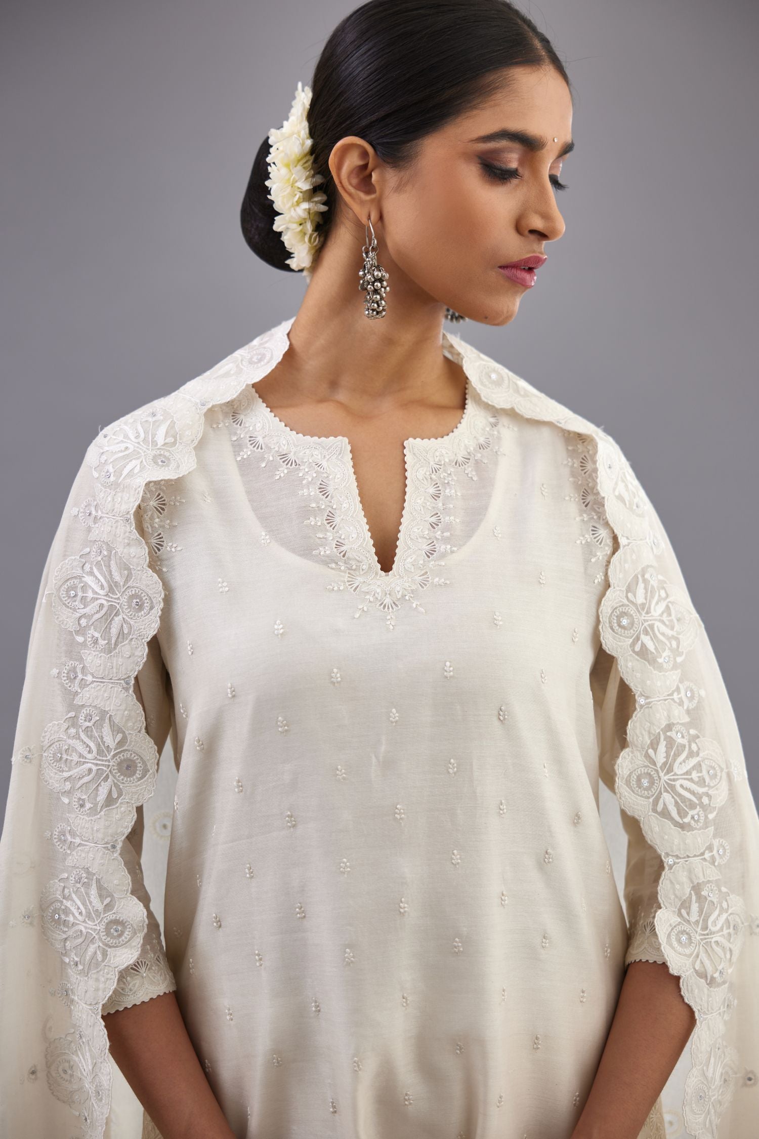 Off white silk chanderi straight kurta set with dori and silk thread embroidery at the neck, armholes, hem and sleeve cuffs.