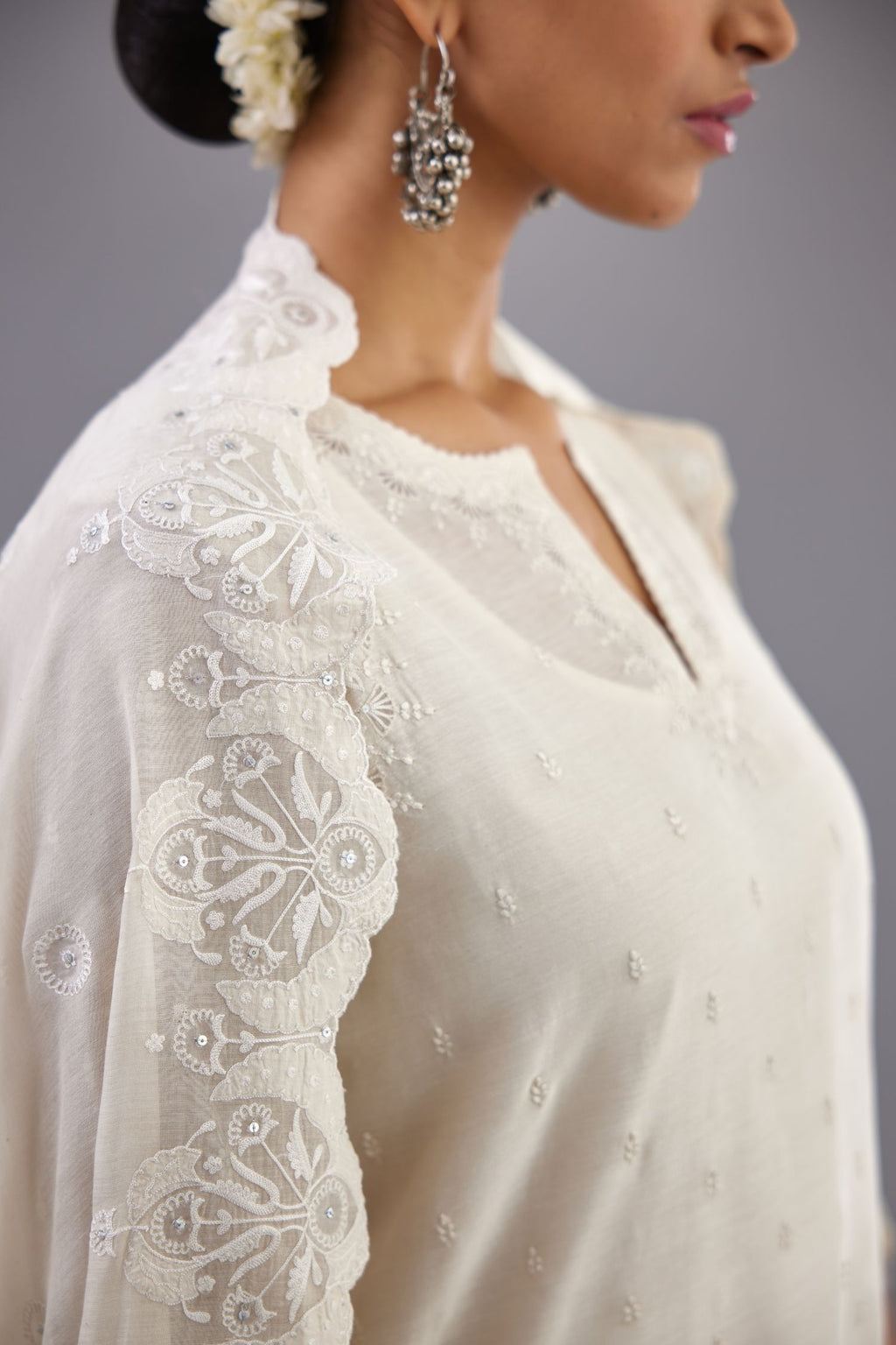 Off white silk chanderi straight kurta set with dori and silk thread embroidery at the neck, armholes, hem and sleeve cuffs.