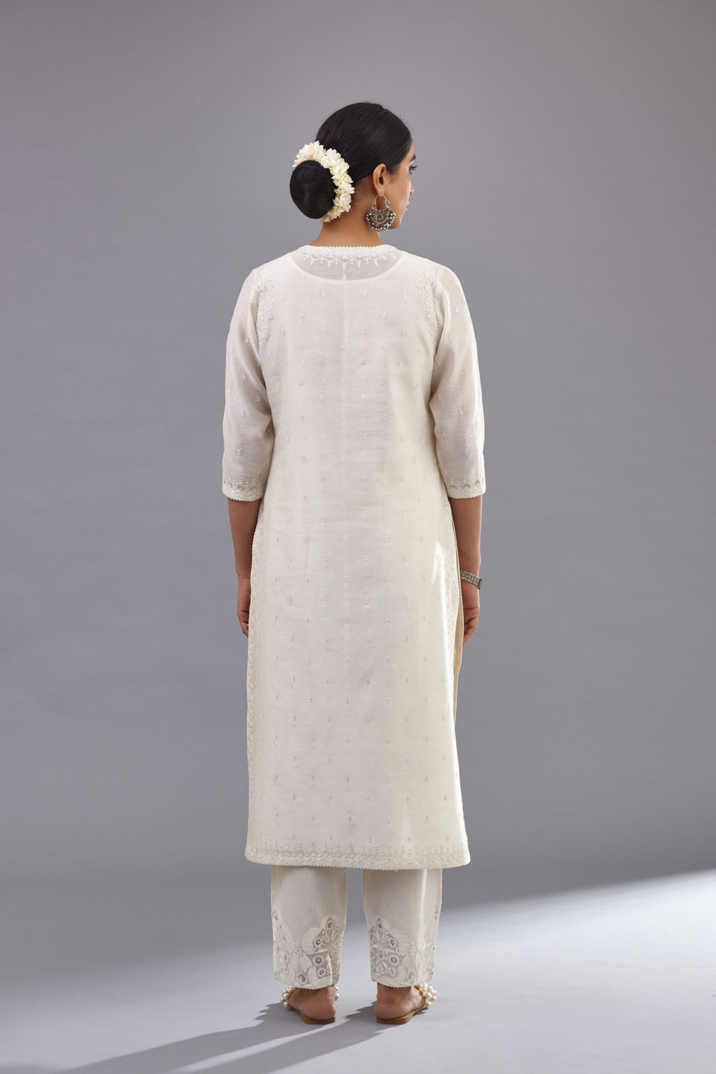 Off white silk chanderi straight kurta set with dori and silk thread embroidery at the neck, armholes, hem and sleeve cuffs.