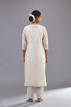Off white silk chanderi straight kurta set with dori and silk thread embroidery at the neck, armholes, hem and sleeve cuffs.