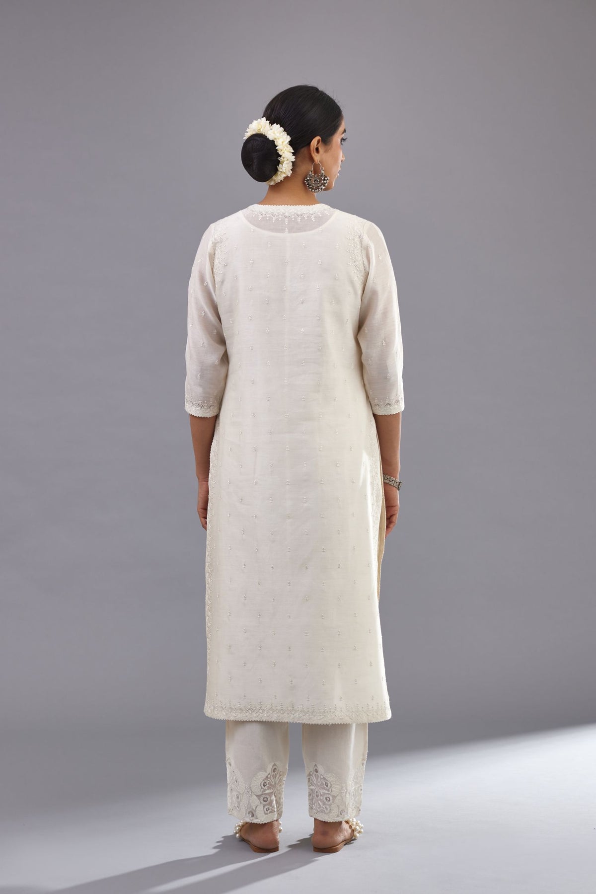 Off white silk chanderi straight kurta set with dori and silk thread embroidery at the neck, armholes, hem and sleeve cuffs.