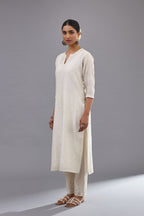 Off white silk chanderi straight kurta set with dori and silk thread embroidery at the neck, armholes, hem and sleeve cuffs.