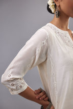 Off white silk chanderi straight kurta set with dori and silk thread chhari - stripes, all over and heavier butas at hem.