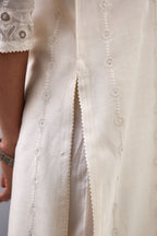 Off white silk chanderi straight kurta set with dori and silk thread chhari - stripes, all over and heavier butas at hem.