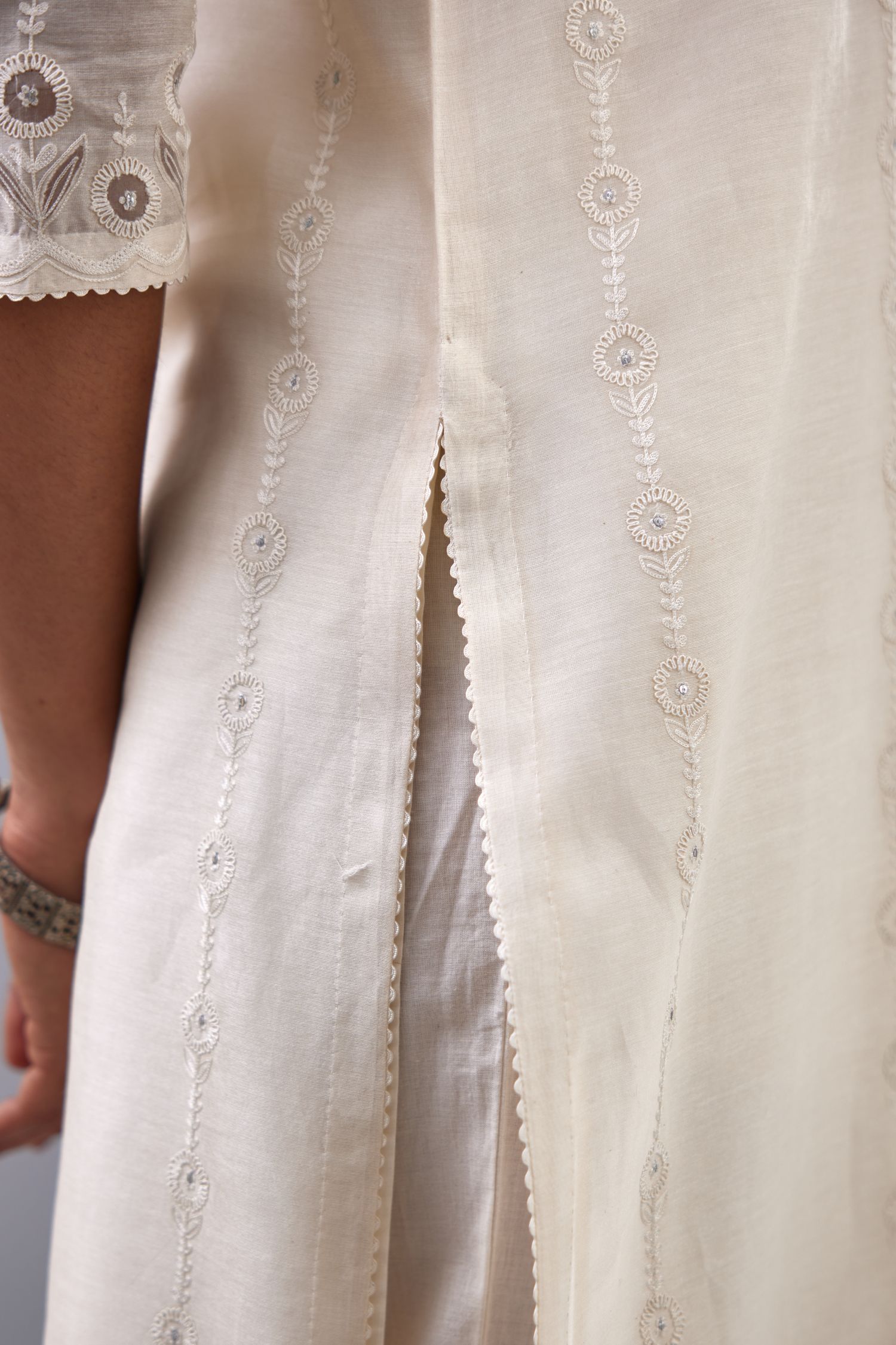 Off white silk chanderi straight kurta set with dori and silk thread chhari - stripes, all over and heavier butas at hem.