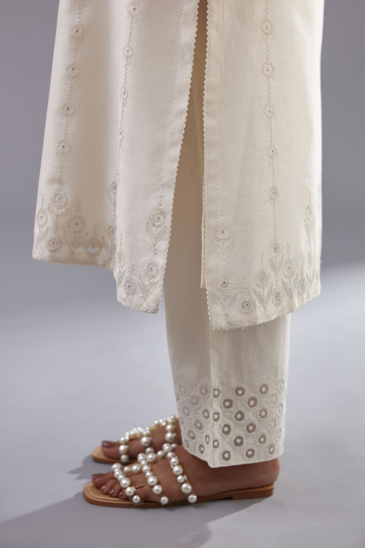 Off white silk chanderi straight kurta set with dori and silk thread chhari - stripes, all over and heavier butas at hem.