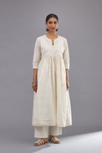 Handspun handwoven cotton  kurta set with wavy empire waistline and gathers, highlighted with all-over tonal colored thread embroidery and ric-rac detail.