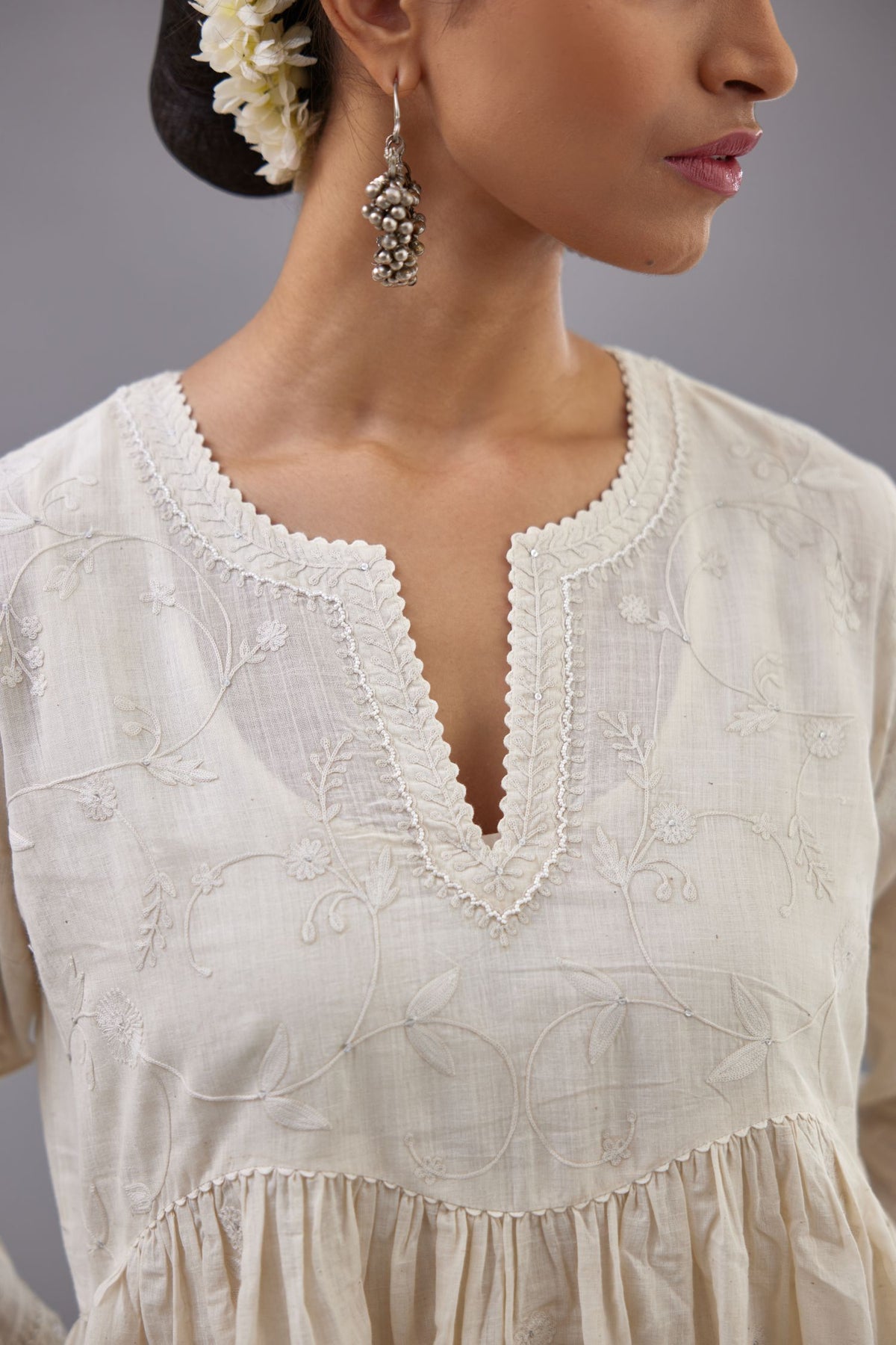 Handspun handwoven cotton  kurta set with wavy empire waistline and gathers, highlighted with all-over tonal colored thread embroidery and ric-rac detail.