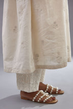 Handspun handwoven cotton  kurta set with wavy empire waistline and gathers, highlighted with all-over tonal colored thread embroidery and ric-rac detail.