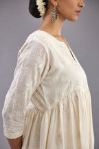 Handspun handwoven cotton  kurta set with wavy empire waistline and gathers, highlighted with all-over tonal colored thread embroidery and ric-rac detail.
