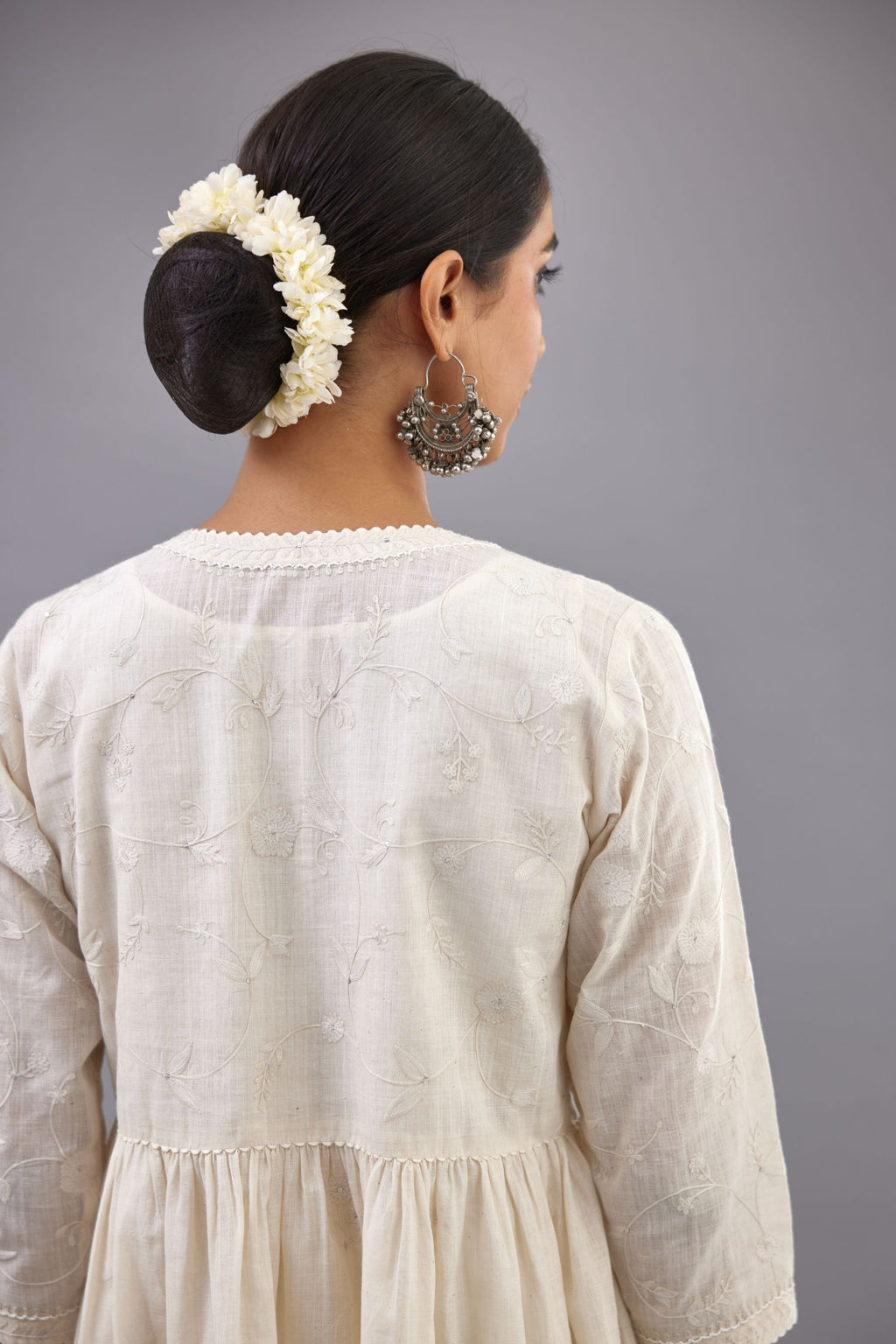 Handspun handwoven cotton  kurta set with wavy empire waistline and gathers, highlighted with all-over tonal colored thread embroidery and ric-rac detail.