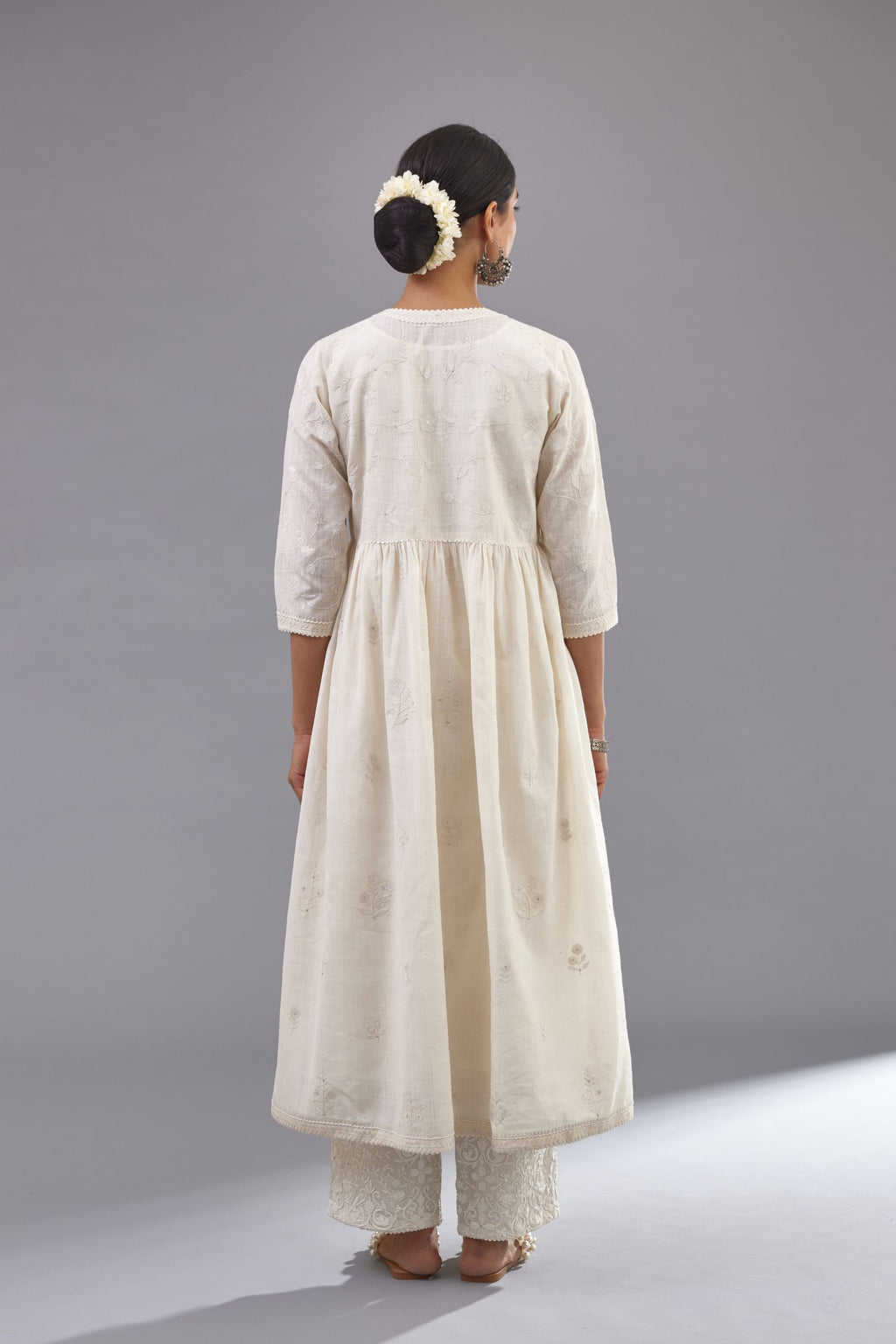 Handspun handwoven cotton  kurta set with wavy empire waistline and gathers, highlighted with all-over tonal colored thread embroidery and ric-rac detail.