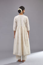 Handspun handwoven cotton  kurta set with wavy empire waistline and gathers, highlighted with all-over tonal colored thread embroidery and ric-rac detail.
