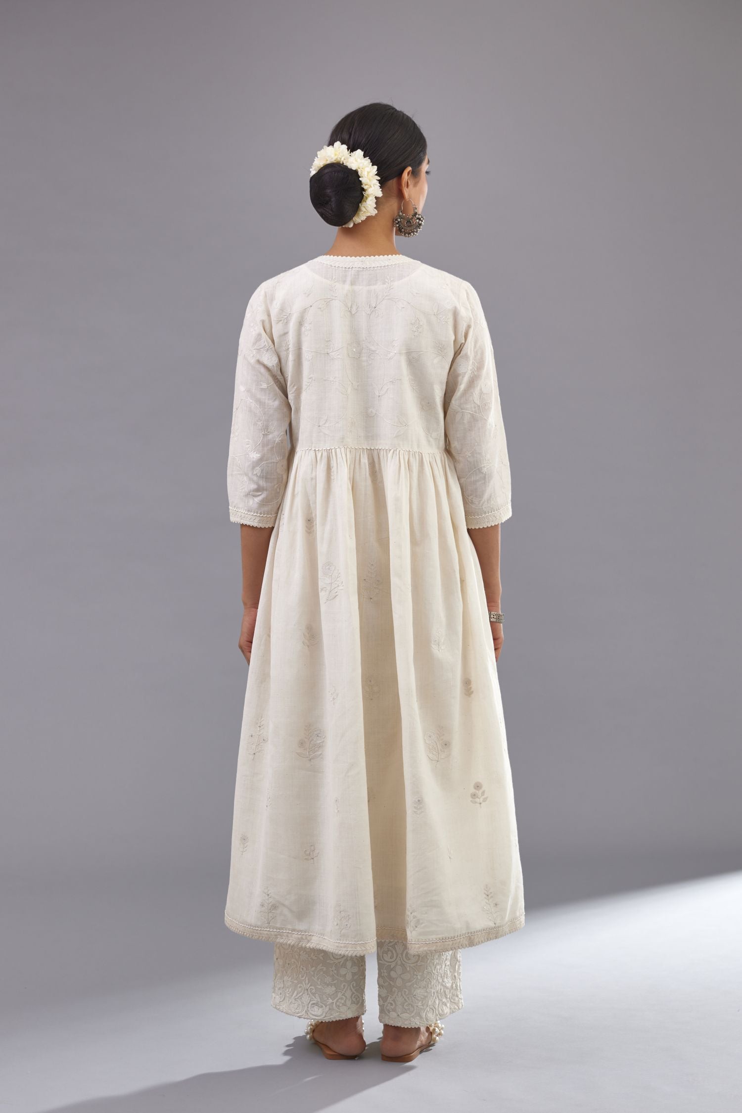 Handspun handwoven cotton  kurta set with wavy empire waistline and gathers, highlighted with all-over tonal colored thread embroidery and ric-rac detail.