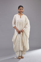 Handspun handwoven cotton  kurta set with wavy empire waistline and gathers, highlighted with all-over tonal colored thread embroidery and ric-rac detail.
