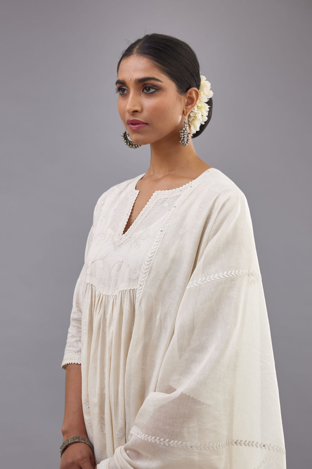 Handspun handwoven cotton  kurta set with wavy empire waistline and gathers, highlighted with all-over tonal colored thread embroidery and ric-rac detail.