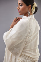 Handspun handwoven cotton  kurta set with wavy empire waistline and gathers, highlighted with all-over tonal colored thread embroidery and ric-rac detail.