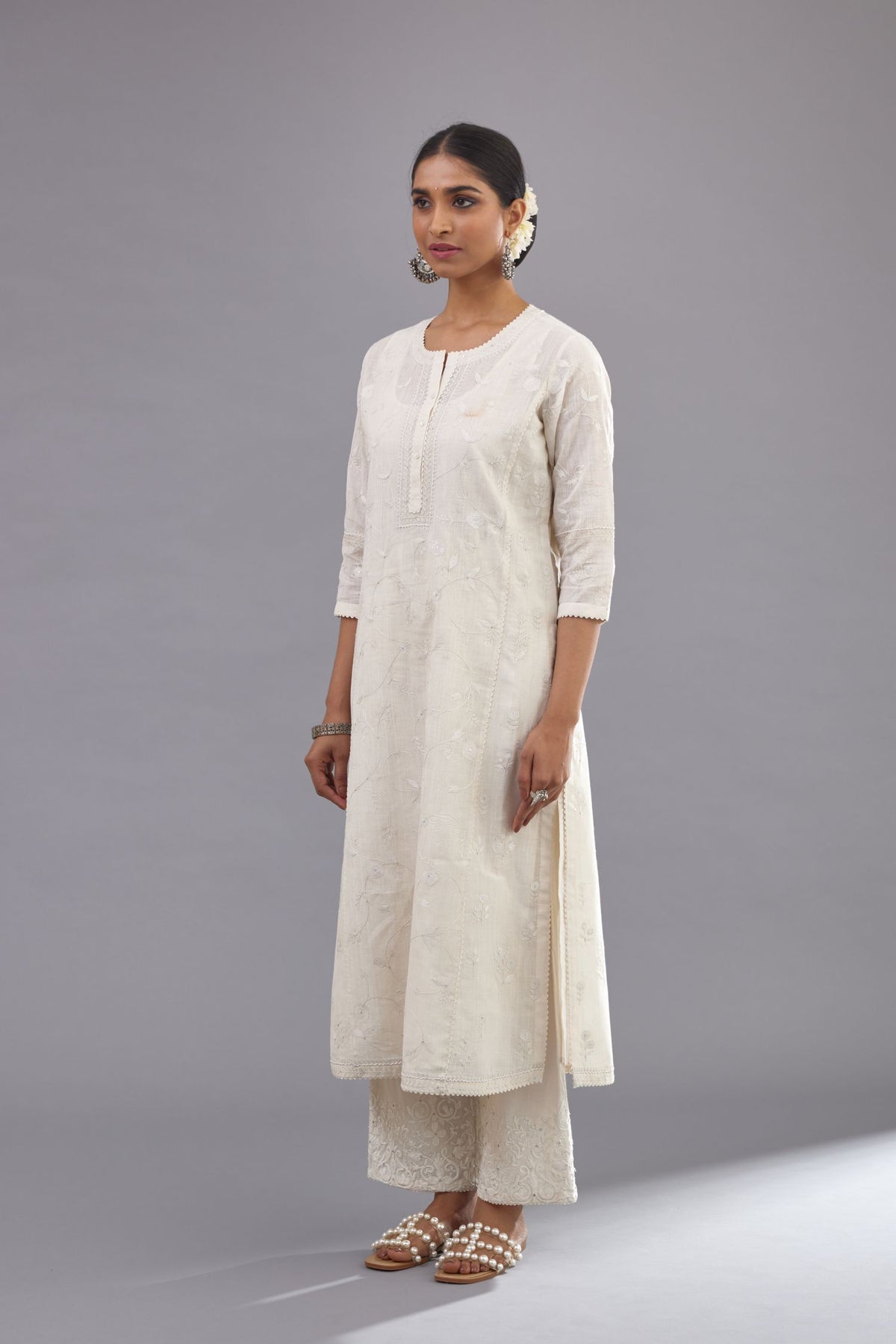 Off-white Handspun handwoven cotton kurta set with all-over jaal embroidery and small assorted flowers embroidery at side panells, highlighted with sequins handwork.