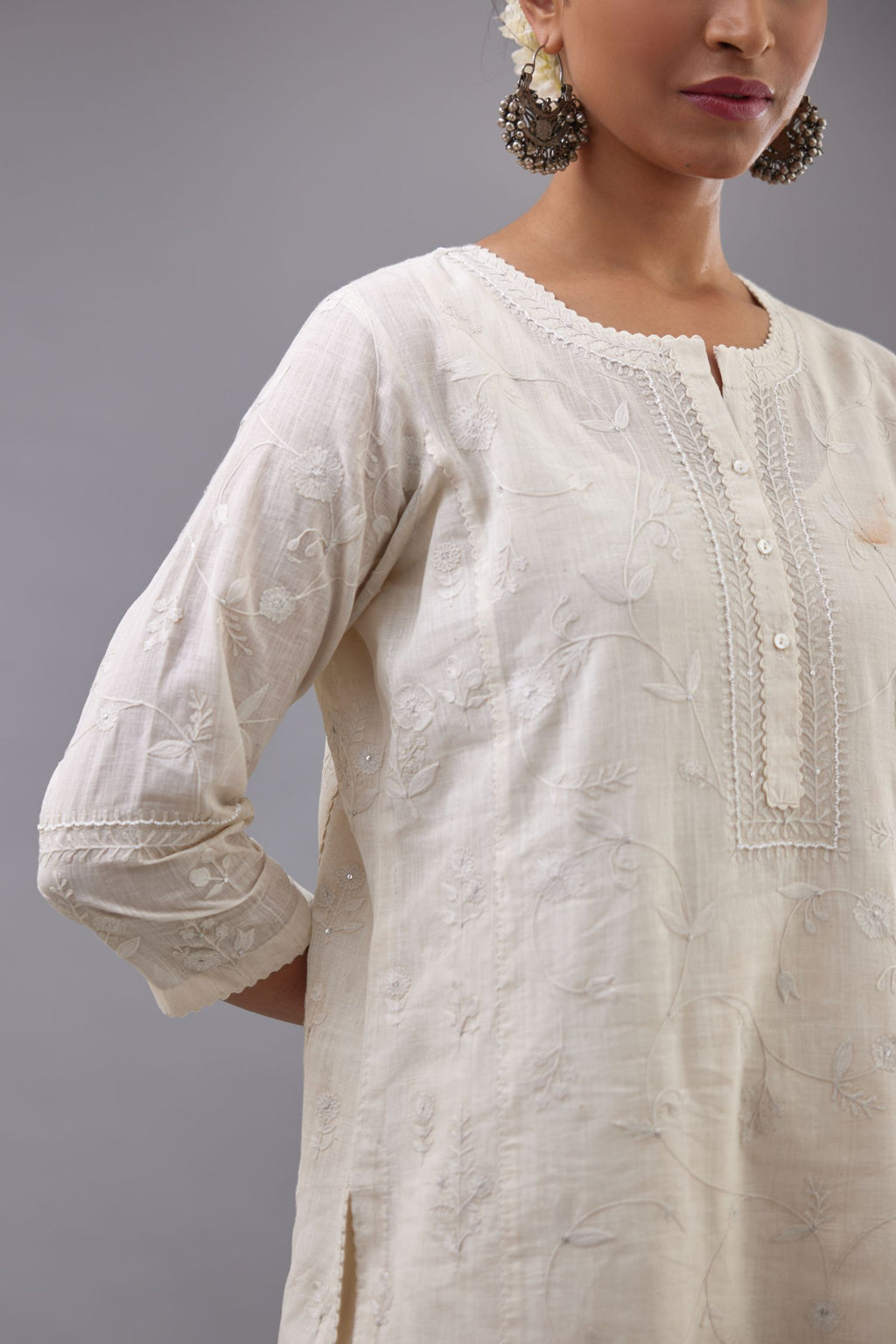 Off-white Handspun handwoven cotton kurta set with all-over jaal embroidery and small assorted flowers embroidery at side panells, highlighted with sequins handwork.