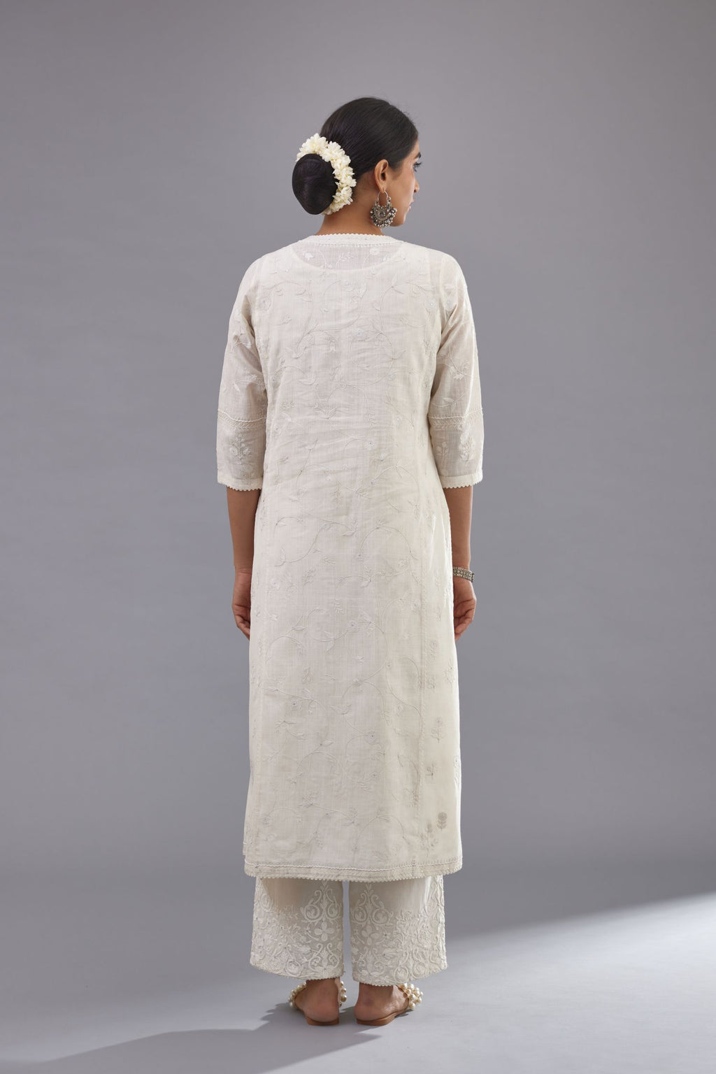 Off-white Handspun handwoven cotton kurta set with all-over jaal embroidery and small assorted flowers embroidery at side panells, highlighted with sequins handwork.