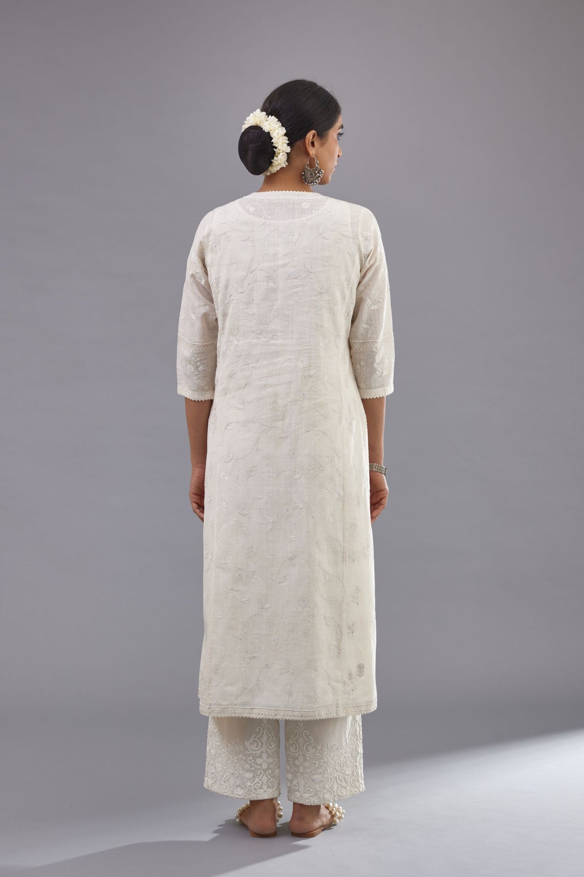Off-white Handspun handwoven cotton kurta set with all-over jaal embroidery and small assorted flowers embroidery at side panells, highlighted with sequins handwork.