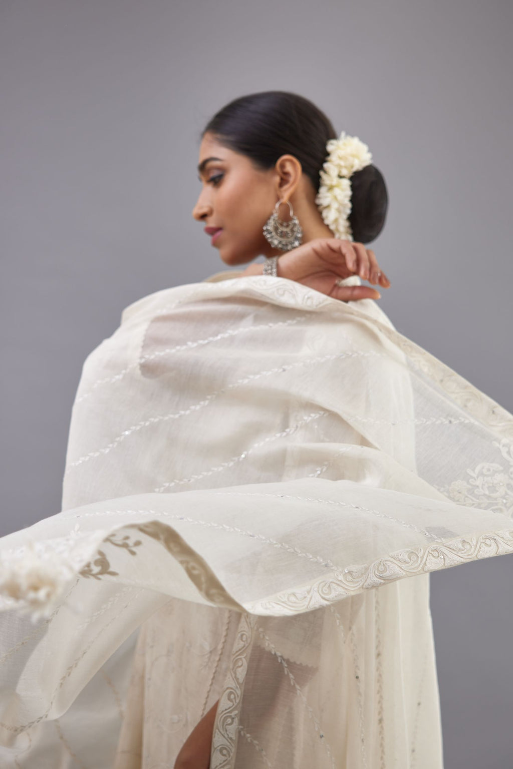 Off-white Handspun handwoven cotton kurta set with all-over jaal embroidery and small assorted flowers embroidery at side panells, highlighted with sequins handwork.