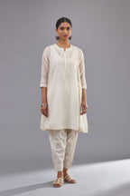 Off white cotton chanderi short kalidar phiran style kurta set with button placket neckline and dori and silk thraed embroidery all over.