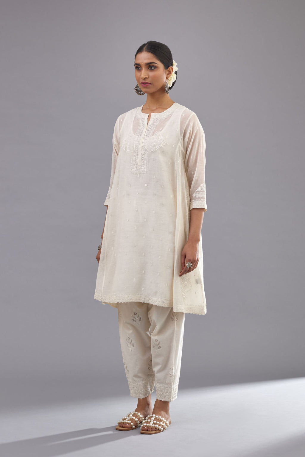 Off white cotton chanderi short kalidar phiran style kurta set with button placket neckline and dori and silk thraed embroidery all over.