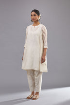 Off white cotton chanderi short kalidar phiran style kurta set with button placket neckline and dori and silk thraed embroidery all over.
