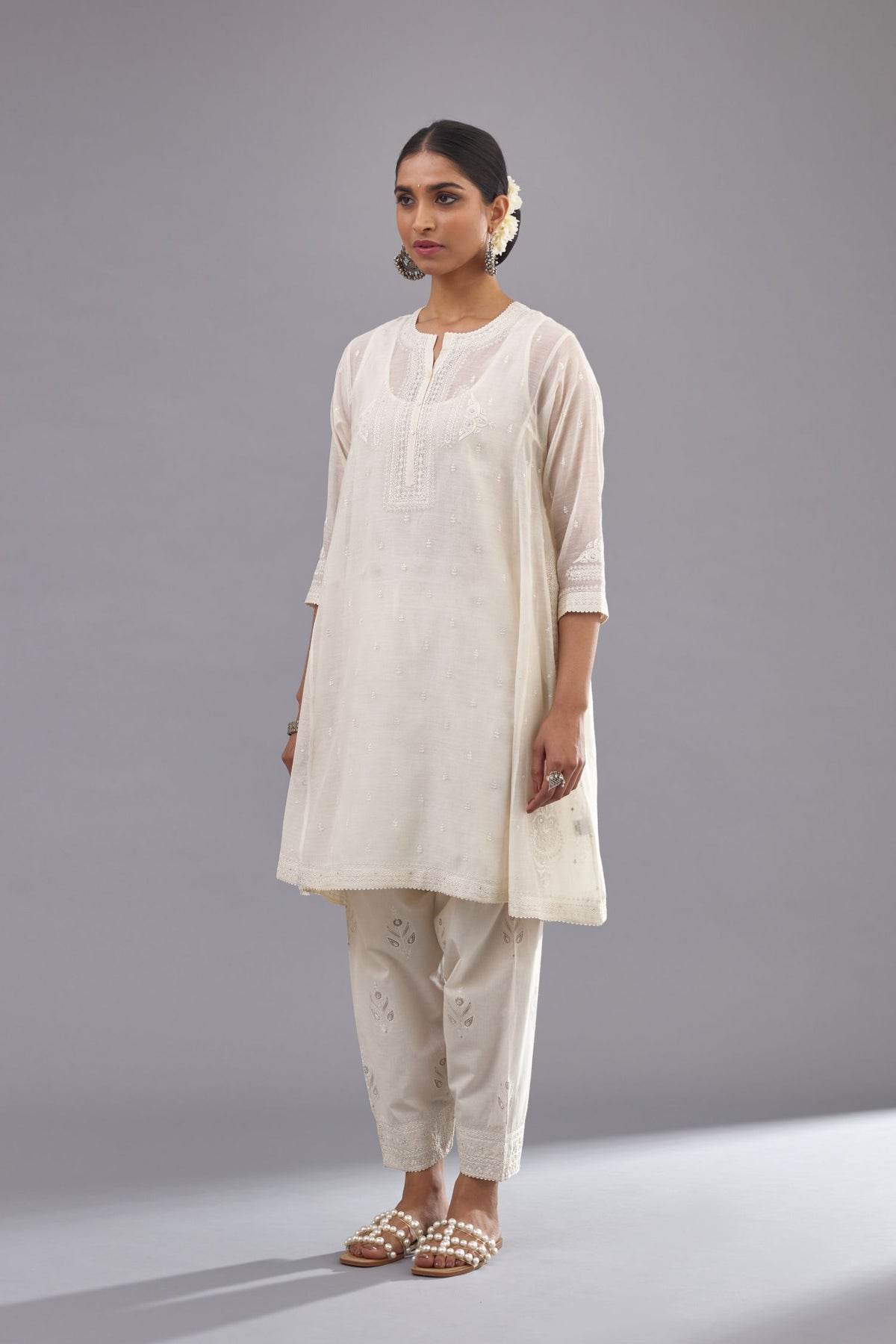 Off white cotton chanderi short kalidar phiran style kurta set with button placket neckline and dori and silk thraed embroidery all over.