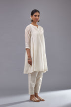 Off white cotton chanderi short kalidar phiran style kurta set with button placket neckline and dori and silk thraed embroidery all over.