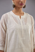Off white cotton chanderi short kalidar phiran style kurta set with button placket neckline and dori and silk thraed embroidery all over.