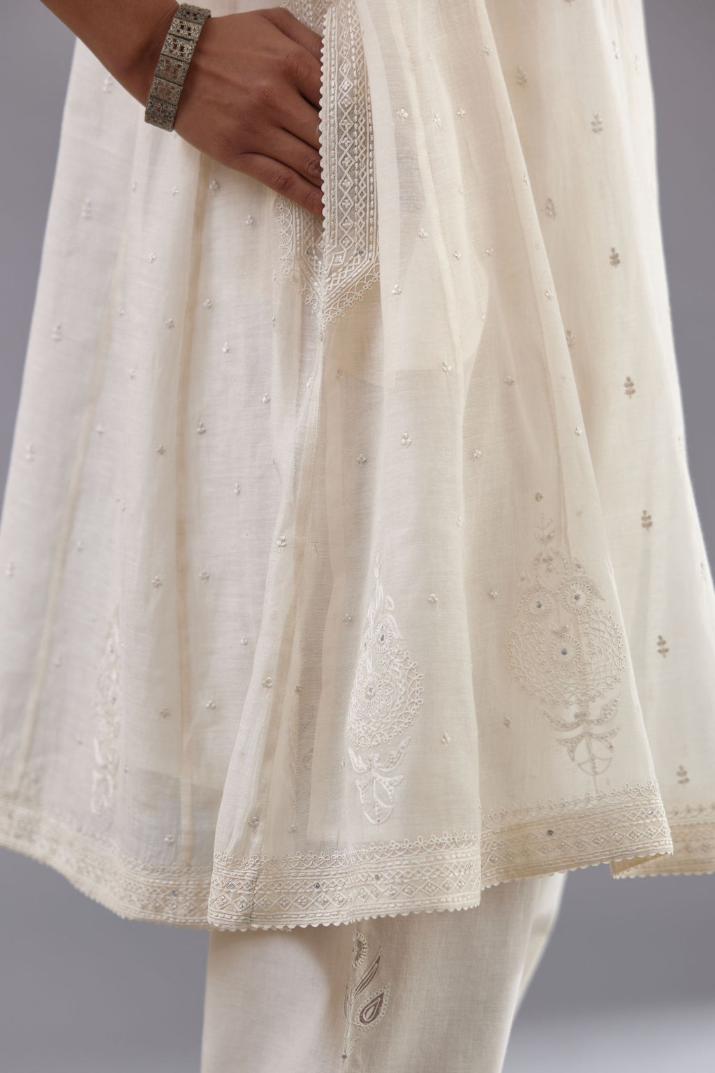 Off white cotton chanderi short kalidar phiran style kurta set with button placket neckline and dori and silk thraed embroidery all over.