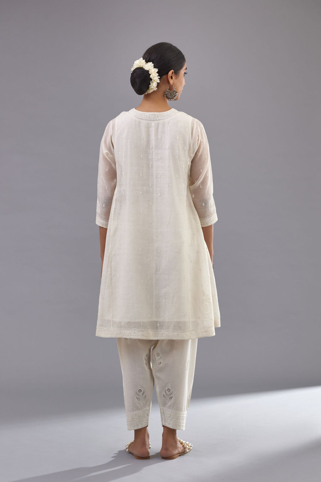 Off white cotton chanderi short kalidar phiran style kurta set with button placket neckline and dori and silk thraed embroidery all over.