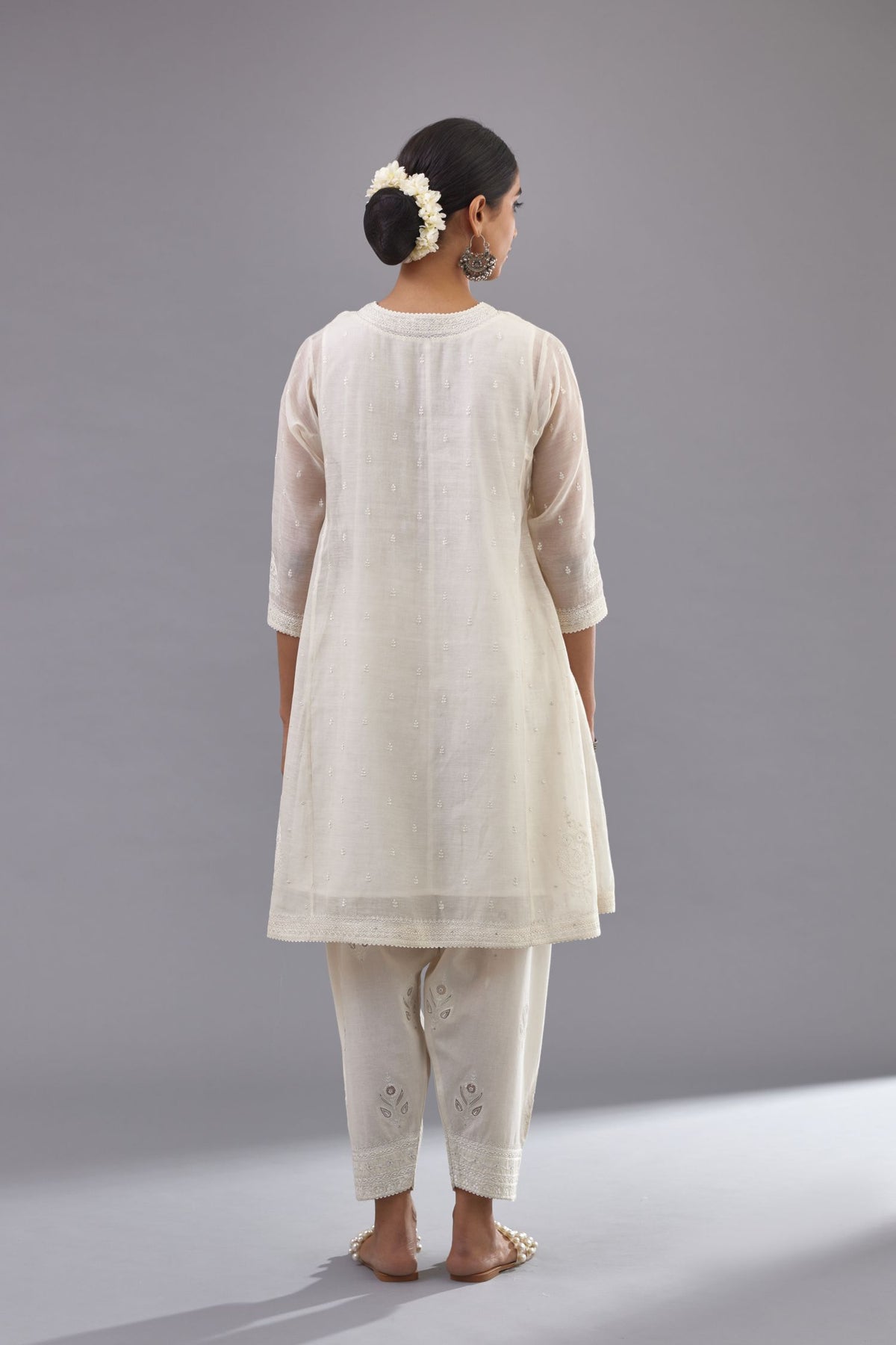 Off white cotton chanderi short kalidar phiran style kurta set with button placket neckline and dori and silk thraed embroidery all over.