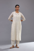 Off-white cotton chanderi kurta set with all-over jaal embroidery and small assorted flowers embroidery at side panells, highlighted with sequins handwork.