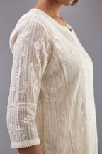 Off-white cotton chanderi kurta set with all-over jaal embroidery and small assorted flowers embroidery at side panells, highlighted with sequins handwork.