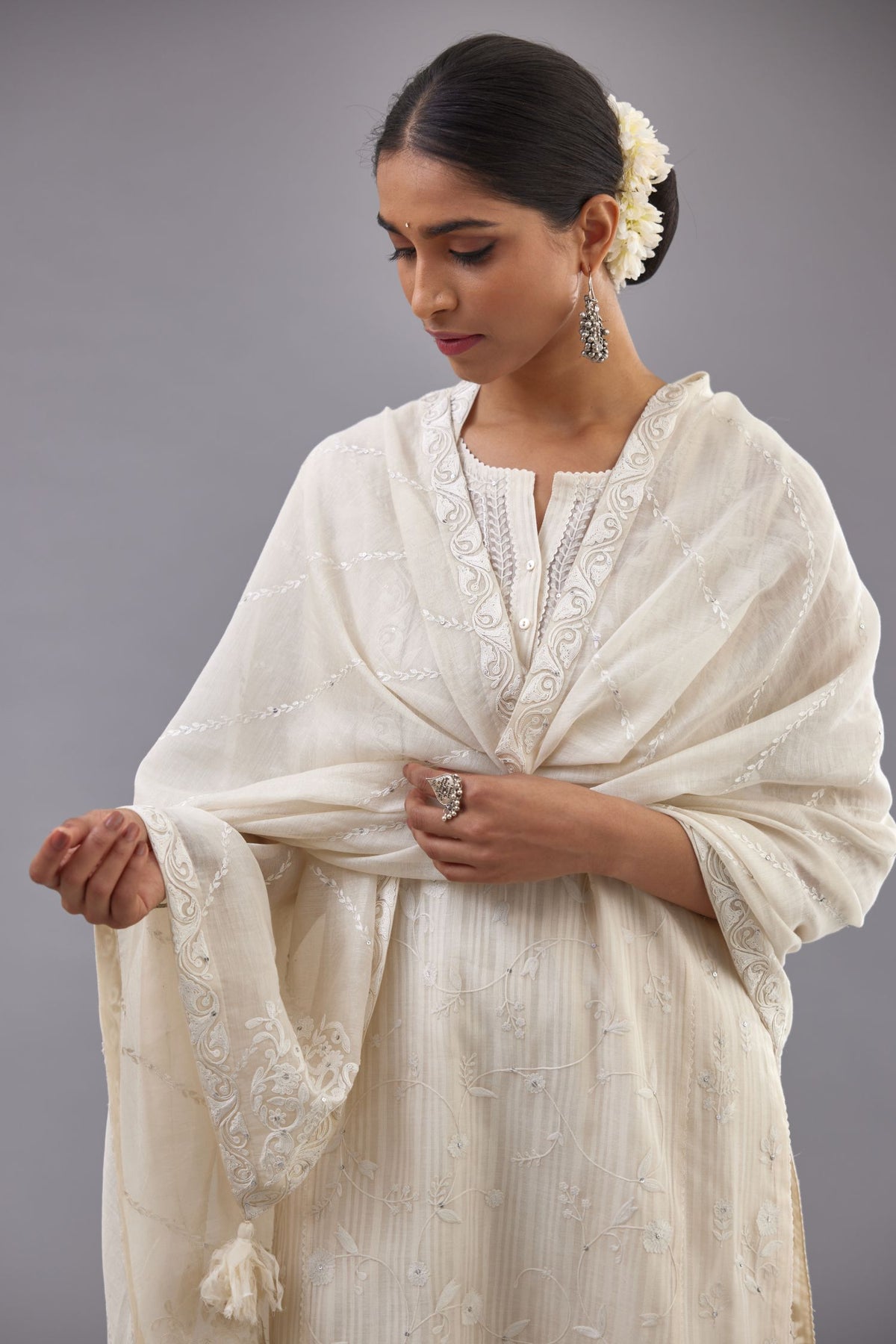 Off-white cotton chanderi kurta set with all-over jaal embroidery and small assorted flowers embroidery at side panells, highlighted with sequins handwork.