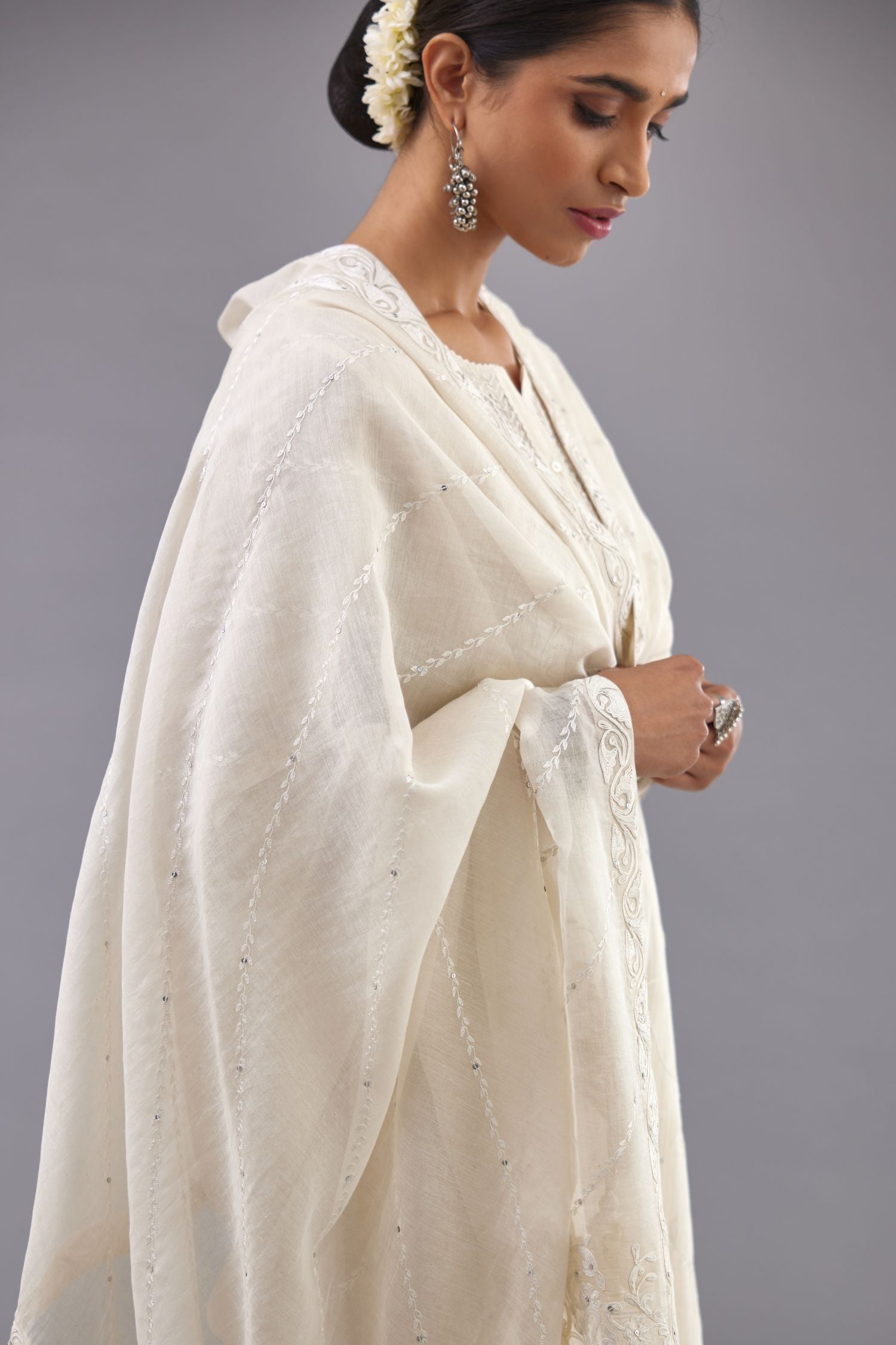 Off-white cotton chanderi kurta set with all-over jaal embroidery and small assorted flowers embroidery at side panells, highlighted with sequins handwork.