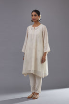 Off-white cotton chanderi A-line kurta set with all-over assorted flowers embroidery, highlighted with sequins handwork.