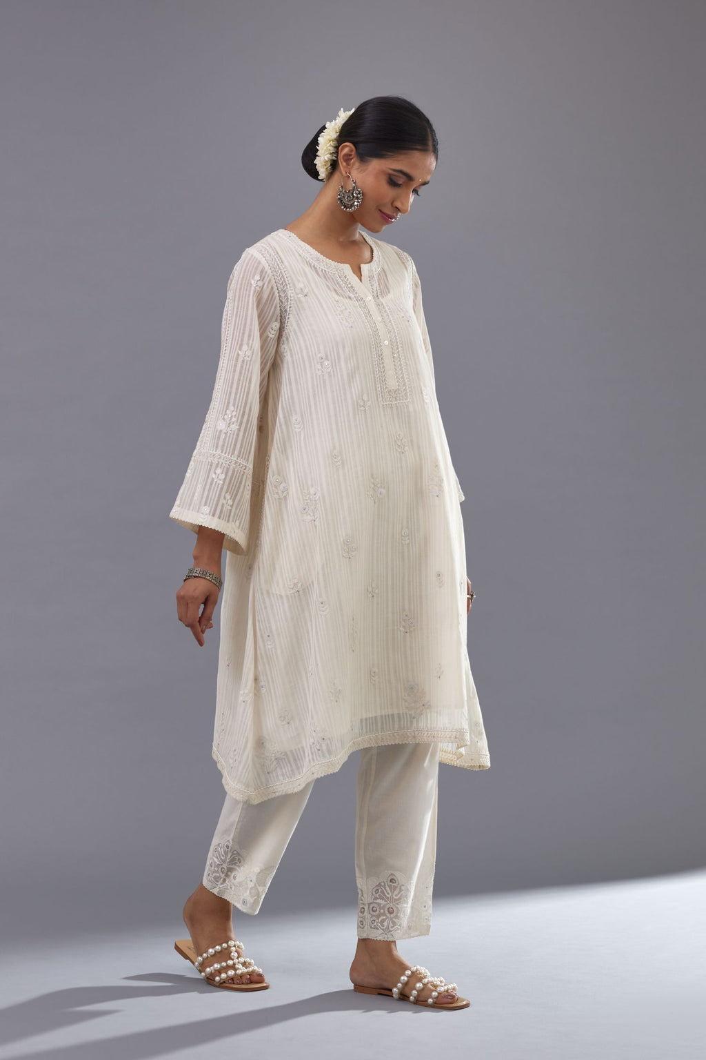 Off-white cotton chanderi A-line kurta set with all-over assorted flowers embroidery, highlighted with sequins handwork.